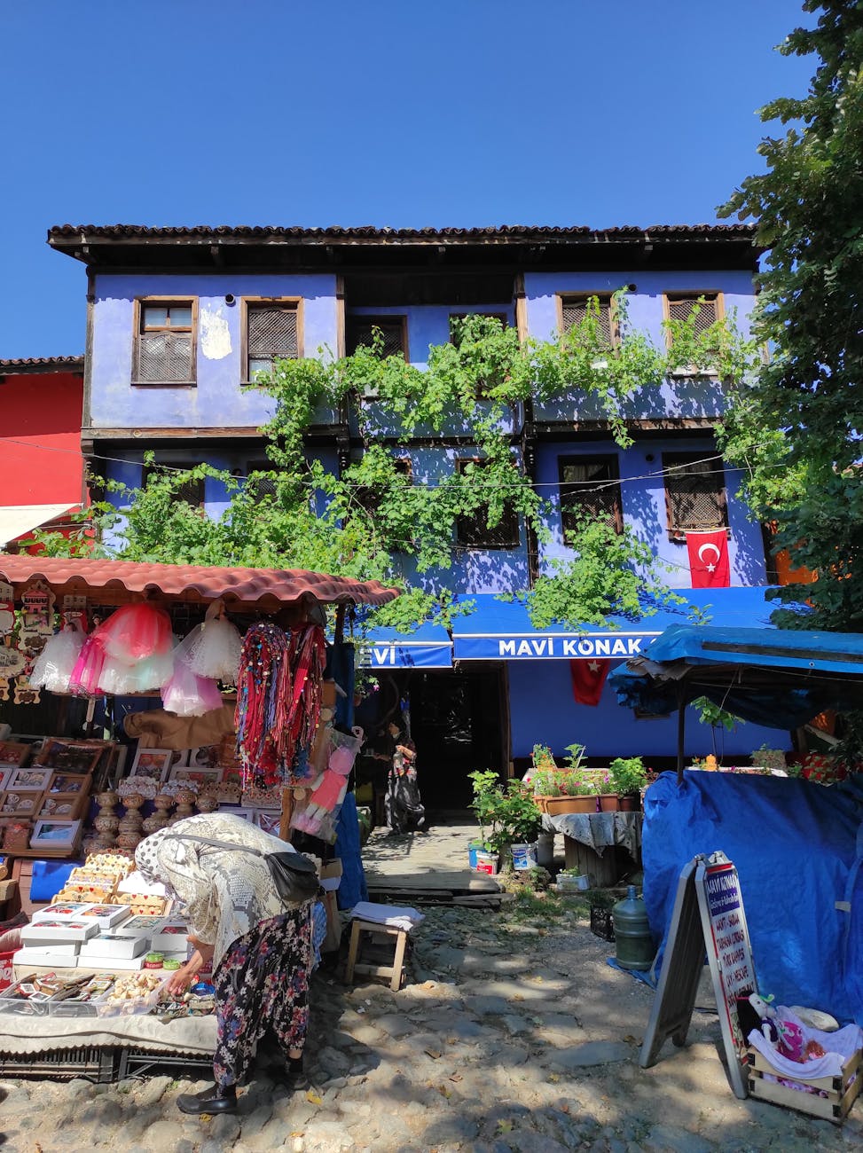 a colorful building with a blue roof and a market